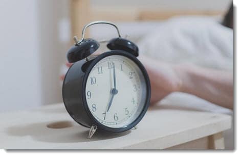 Clock beside bed